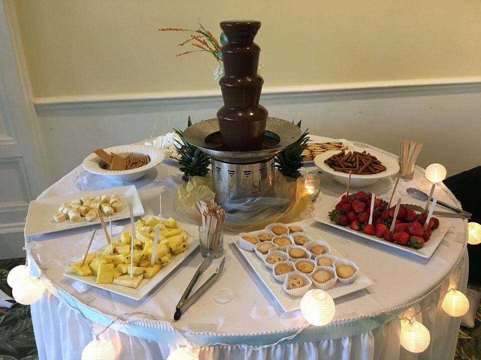 beautiful chocolate fountain with dippables surrounding it