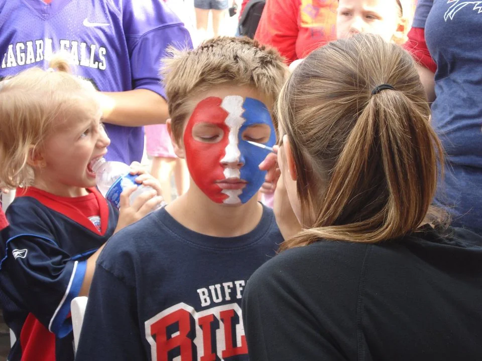 boy wearing red white and blue colors on face
