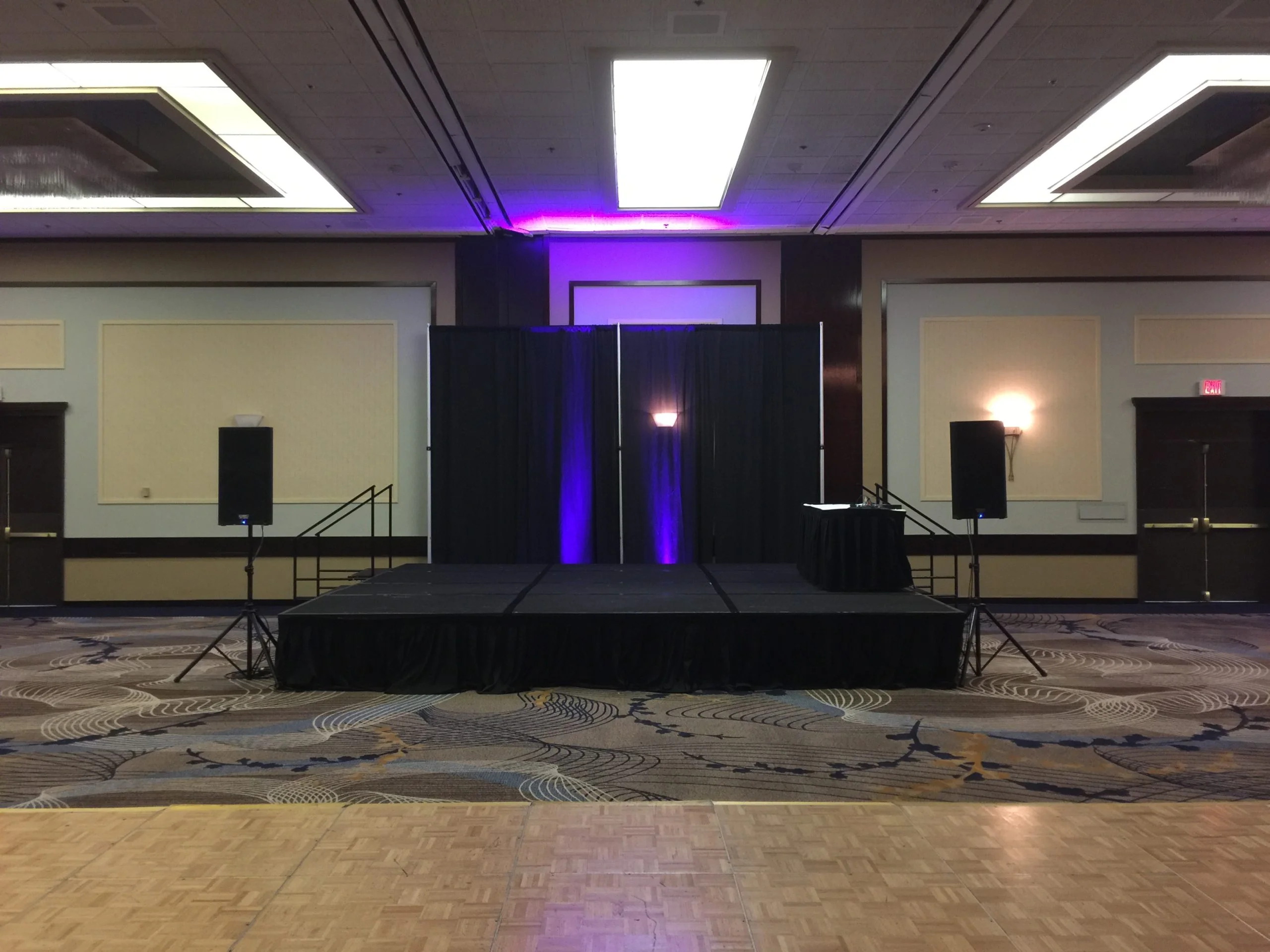 corporate set of up sound sytem staging and pipe drape scaled