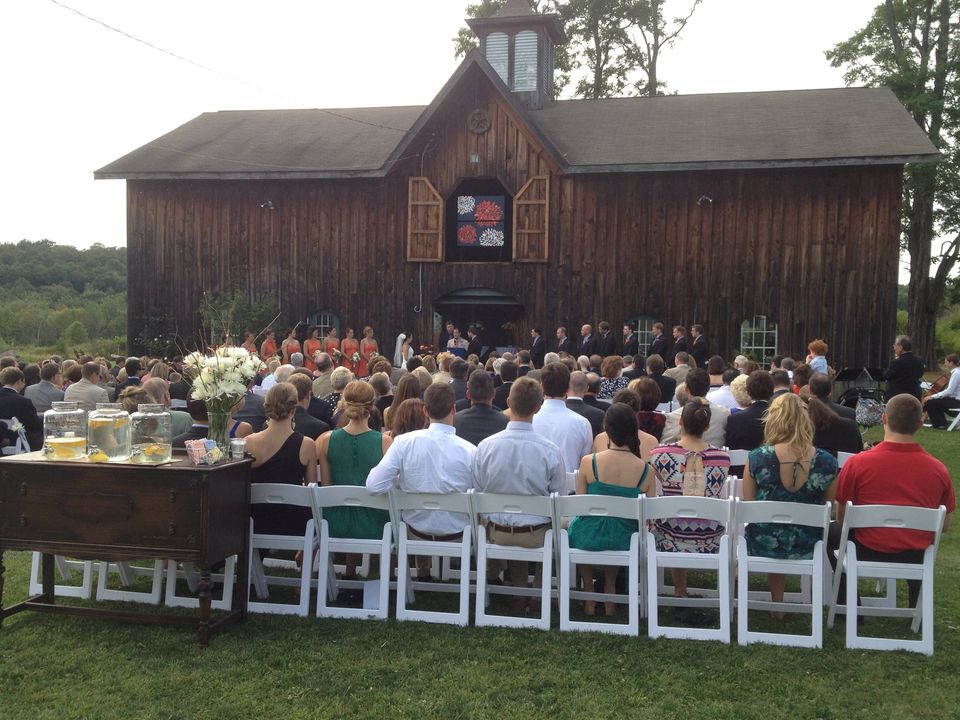 white padded wedding chairs lined up horizontally during outdoor wedding ceremony 1